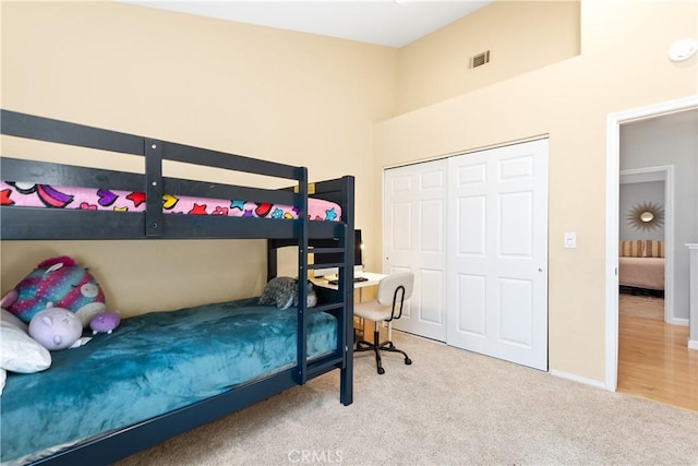 carpeted bedroom with a closet