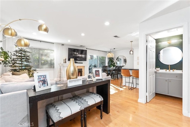 interior space with decorative light fixtures and light hardwood / wood-style floors