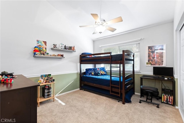 bedroom with ceiling fan and light carpet