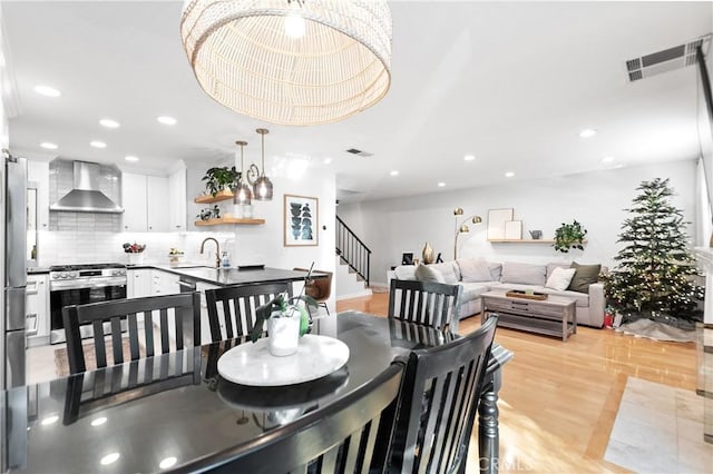 dining room featuring light wood-type flooring and sink