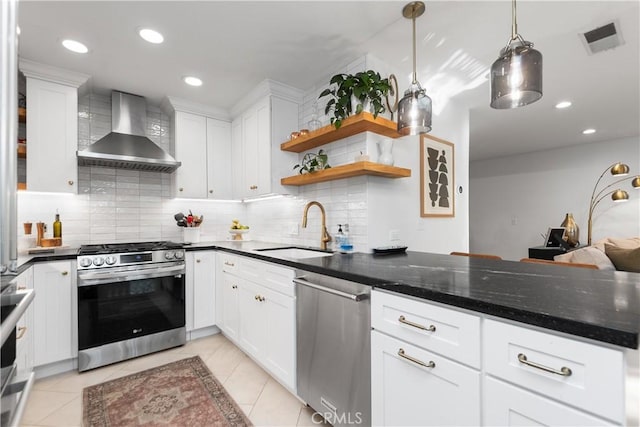 kitchen with white cabinetry, sink, wall chimney exhaust hood, stainless steel appliances, and pendant lighting