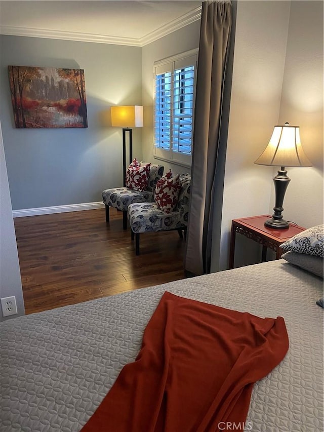 bedroom with hardwood / wood-style flooring and crown molding