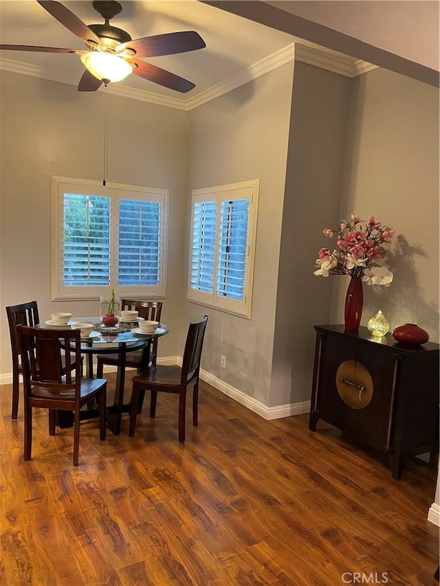 dining area with ceiling fan, crown molding, and dark wood-type flooring