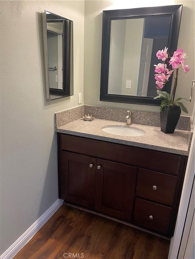 bathroom with vanity and hardwood / wood-style flooring