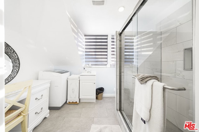 bathroom featuring vanity, tile patterned floors, and a shower with door