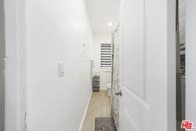 hallway with light hardwood / wood-style flooring