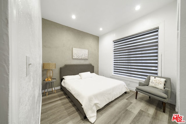 bedroom with light hardwood / wood-style flooring