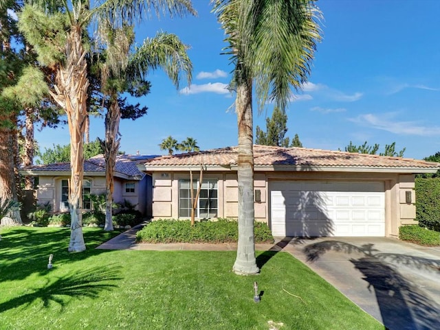 ranch-style house featuring a front lawn and a garage