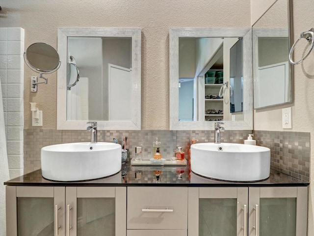 bathroom with tasteful backsplash and vanity