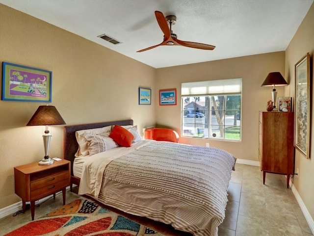 tiled bedroom with ceiling fan