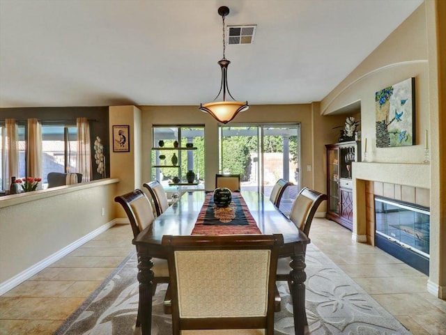 dining area featuring a tiled fireplace