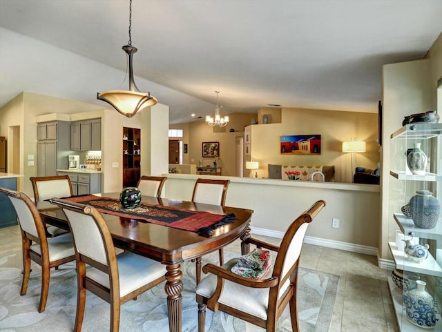 tiled dining room with an inviting chandelier and vaulted ceiling