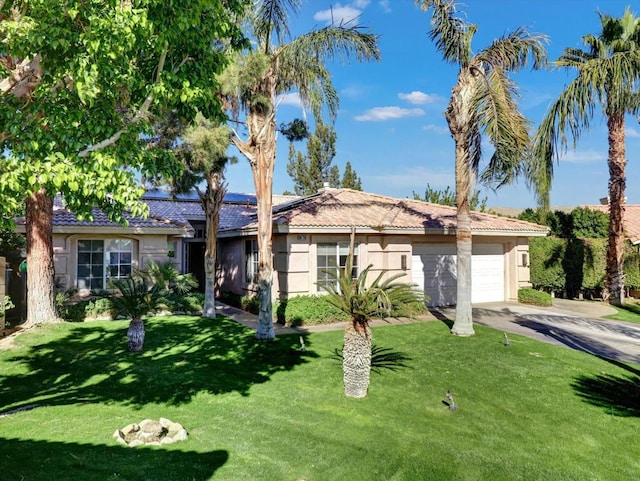 view of front of home with a garage and a front yard