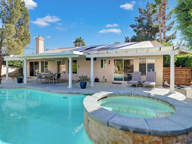 view of pool with an in ground hot tub and a patio area