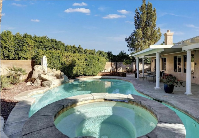 view of pool featuring an in ground hot tub and a patio