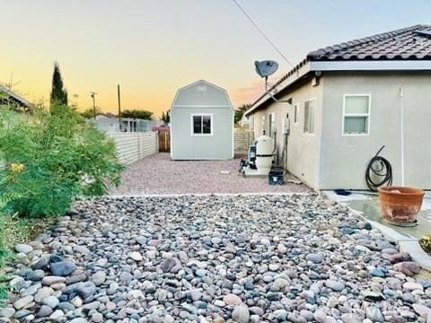 yard at dusk with a storage unit