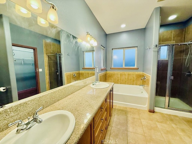 bathroom featuring tile patterned flooring, vanity, and separate shower and tub