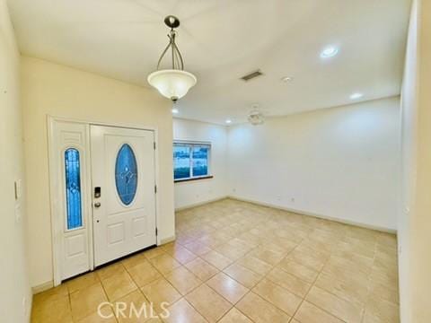 foyer entrance with light tile patterned floors