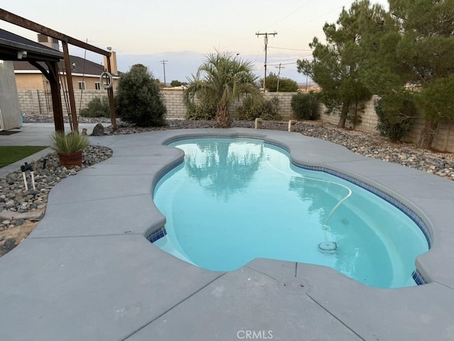 view of pool at dusk