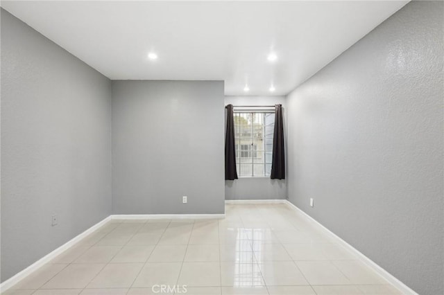 spare room featuring light tile patterned floors