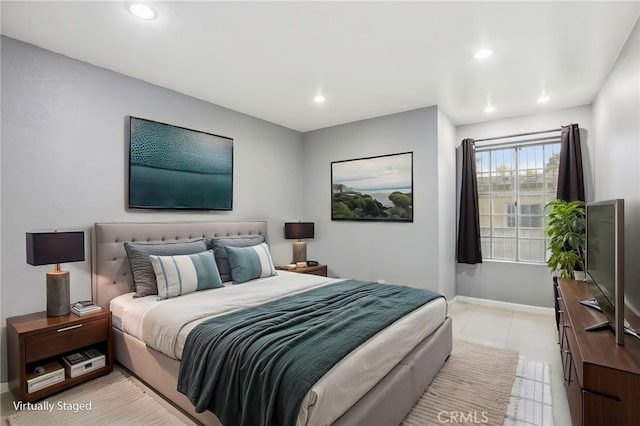 bedroom with light tile patterned floors