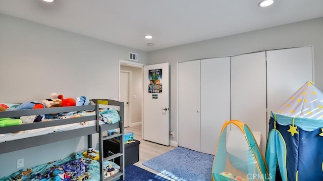 bedroom featuring light wood-type flooring and a closet