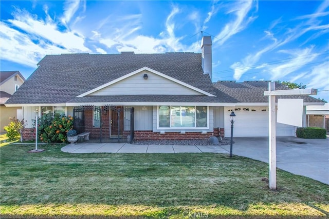 view of front of house with covered porch, a garage, and a front lawn