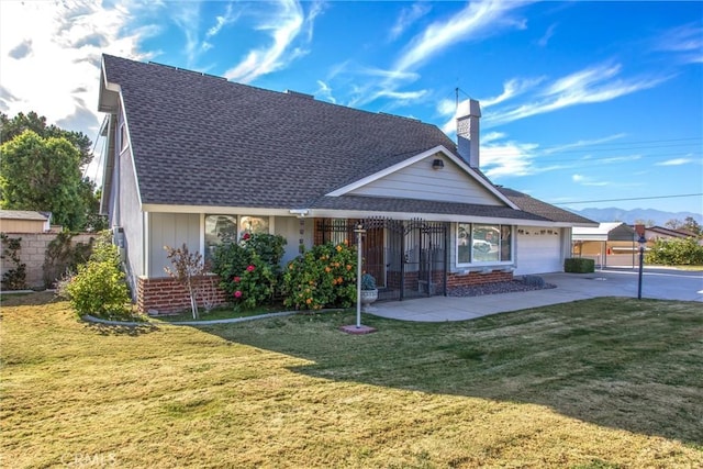 view of front of property featuring a front yard, a porch, and a garage