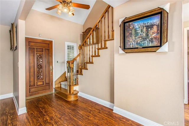 entryway featuring ceiling fan, dark wood-type flooring, and lofted ceiling