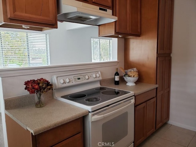 kitchen featuring light tile patterned flooring and electric stove