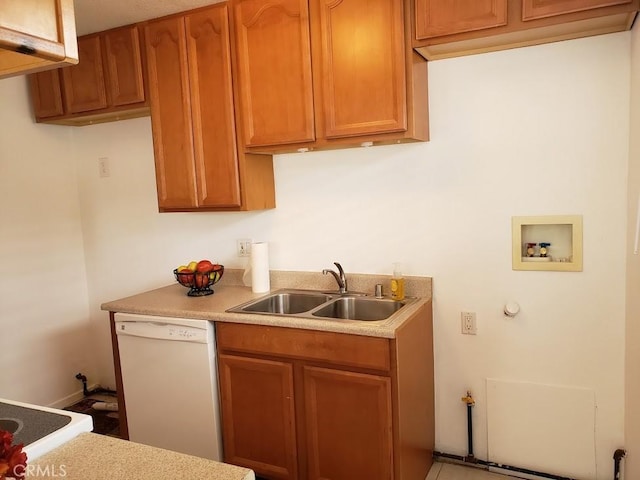 kitchen featuring white dishwasher and sink