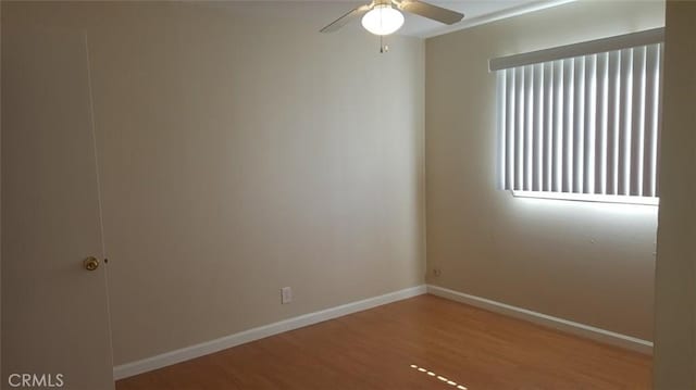 empty room featuring ceiling fan and hardwood / wood-style floors