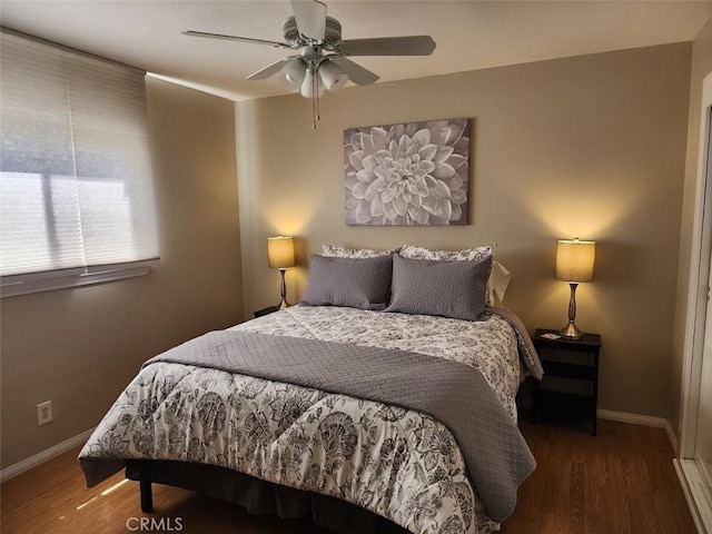 bedroom featuring ceiling fan and dark wood-type flooring