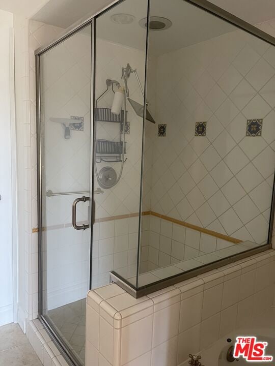 bathroom featuring a shower with shower door