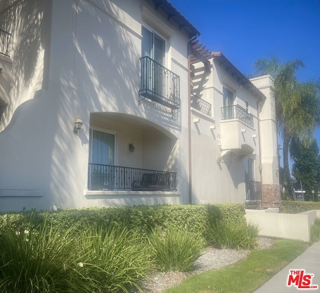 view of property exterior with a balcony