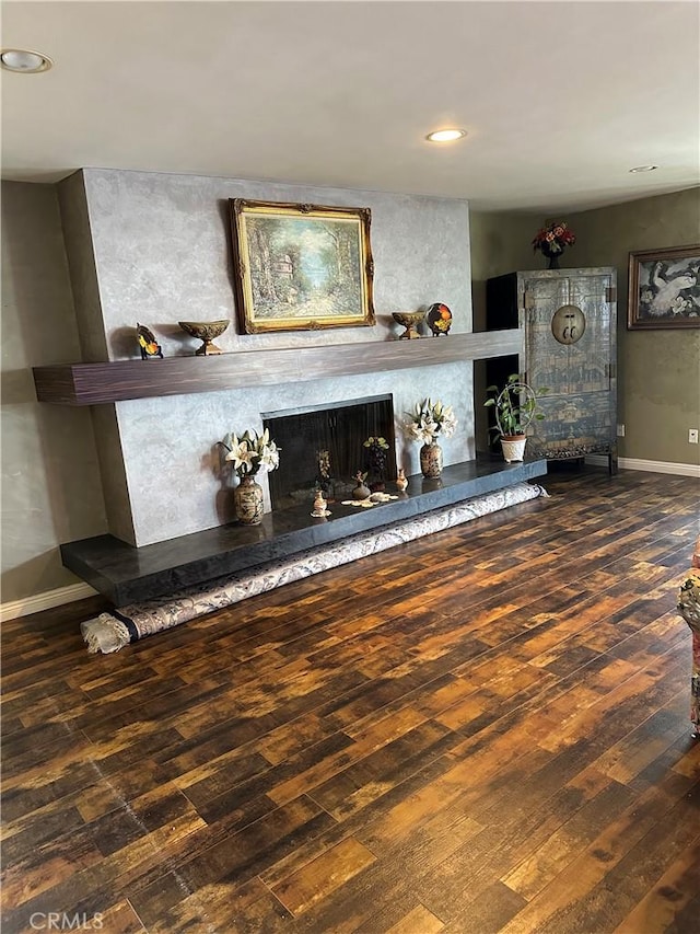 unfurnished living room with dark hardwood / wood-style floors and a fireplace