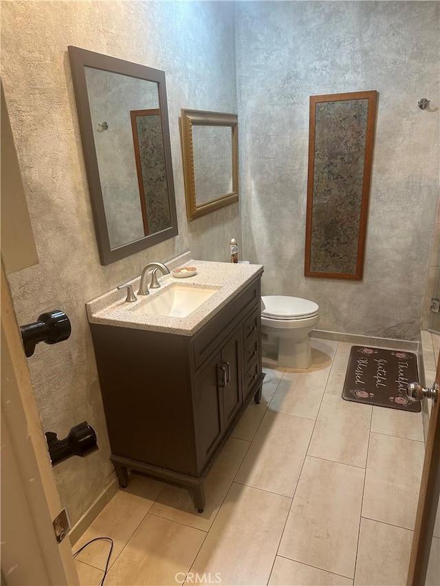 bathroom featuring tile patterned floors, toilet, and vanity