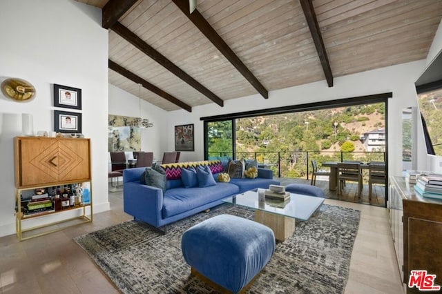 living room featuring hardwood / wood-style flooring, a healthy amount of sunlight, and high vaulted ceiling