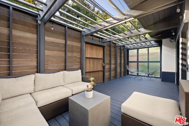 wooden deck featuring a pergola and an outdoor living space