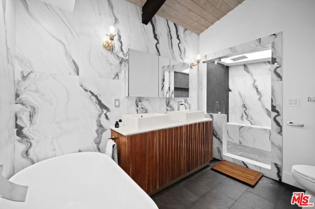 bathroom featuring vaulted ceiling with beams, a bath, toilet, vanity, and tile walls