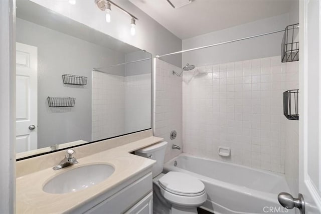 full bathroom with toilet, tiled shower / bath, and vanity