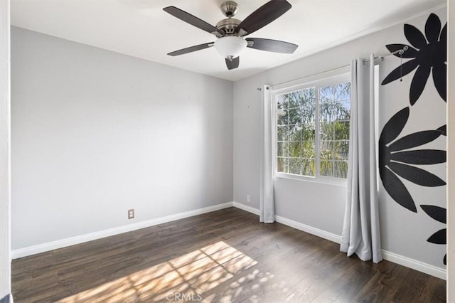 spare room with ceiling fan and dark wood-type flooring