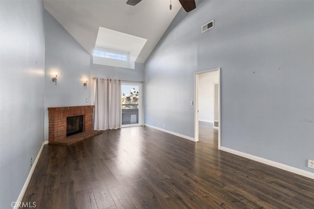 unfurnished living room with beamed ceiling, a fireplace, ceiling fan, dark hardwood / wood-style floors, and high vaulted ceiling