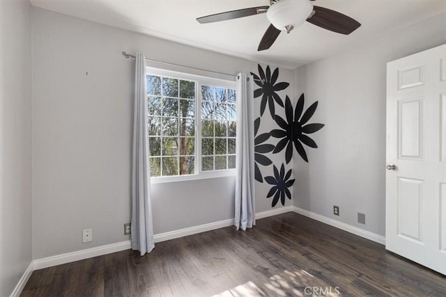 unfurnished room with ceiling fan and dark hardwood / wood-style floors