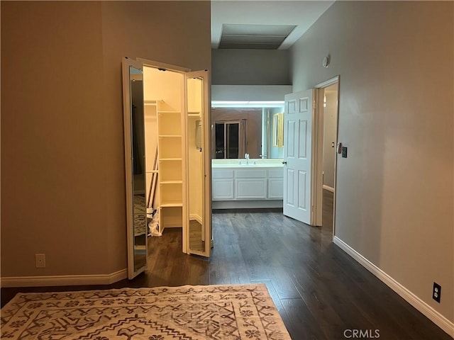 hall featuring dark wood-type flooring and sink