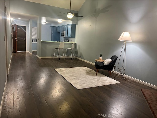 unfurnished room with ceiling fan, dark hardwood / wood-style flooring, and vaulted ceiling