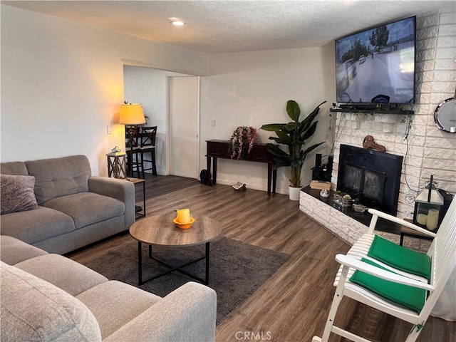 living room featuring dark hardwood / wood-style flooring and a textured ceiling