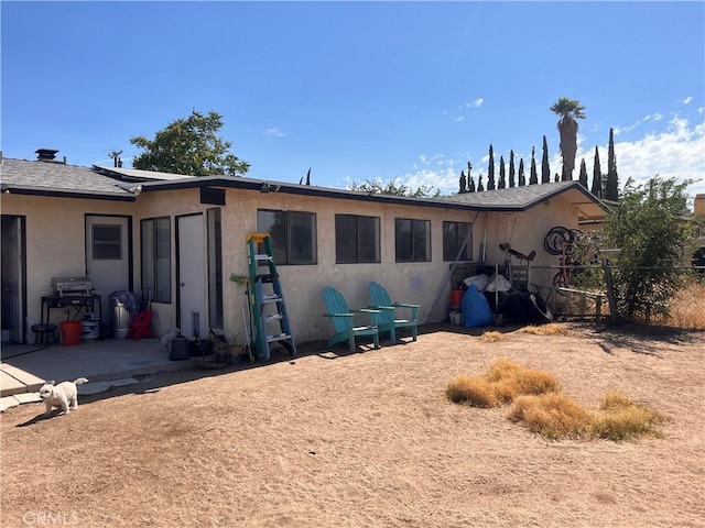 back of house with a patio area