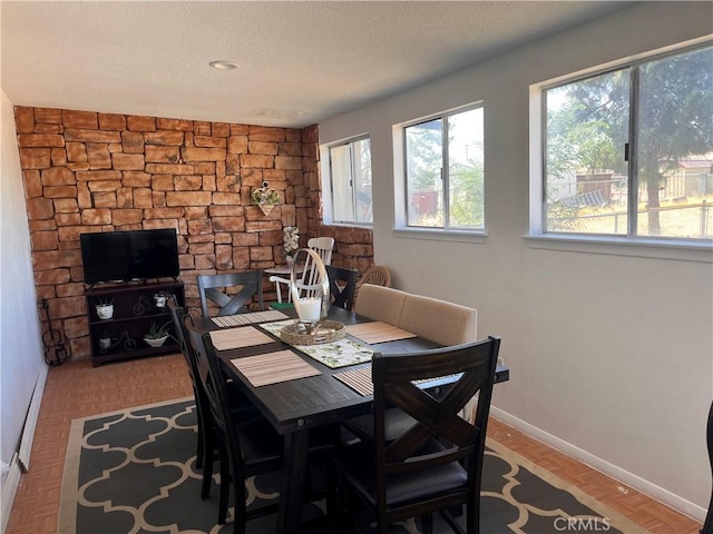 dining room with light parquet floors and a textured ceiling