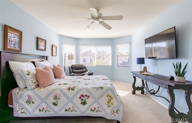 bedroom with ceiling fan, baseboards, and carpet